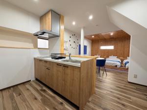 a kitchen with a sink and a bedroom at Famille in Sumoto