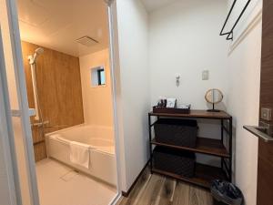 a bathroom with a shower and a bath tub at Famille in Sumoto