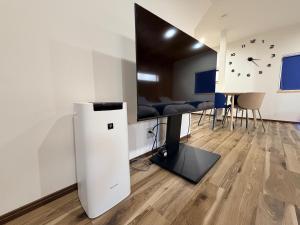 a room with a refrigerator in the middle of a room at Famille in Sumoto
