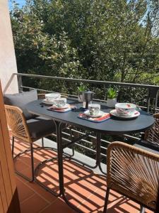 a table and chairs on a balcony with food on it at CuordiSole Tuscany in Montopoli in Val dʼArno