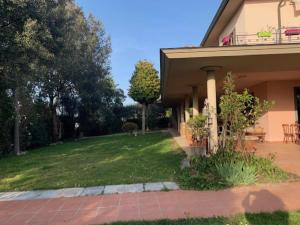 a house with a grass yard and a house at CuordiSole Tuscany in Montopoli in Val dʼArno