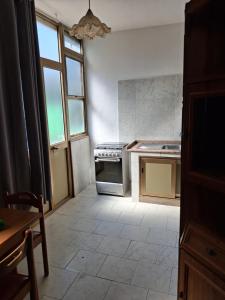 a kitchen with a stove and a window at NEN's House in Alghero