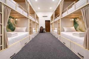 two beds in a room with shelves at Colibri Traditional Hostel in Samarkand