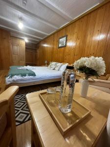 a room with a bed and a table with a vase on it at Morena Mansion in Murighiol +35 photos