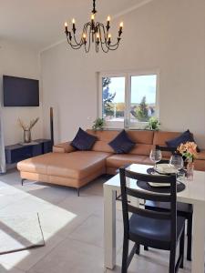 a living room with a couch and a table at Penthouse Vue Panoramique in Mechernich