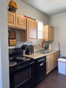 a kitchen with a black stove and a sink at Value Rental no frills in Midvale