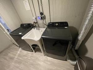 a kitchen with a stove and a sink in a room at Value Rental no frills in Midvale
