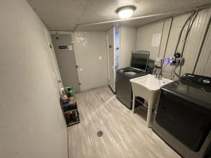 a small room with a desk and a sink in it at Value Rental no frills in Midvale