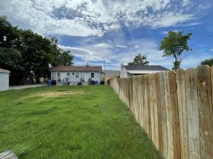 a fence in a yard next to a house at Value Rental no frills in Midvale