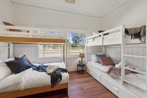 a bedroom with two bunk beds and a window at Peninsula Farm Stay in Somerville +21 photos