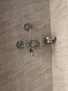 a shower valve in a shower with a tile floor at Monkey Temple Homestay in Kathmandu +59 photos