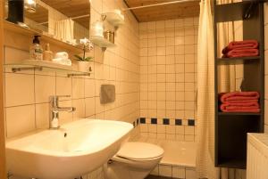 a white bathroom with a sink and a toilet at Klaushausen Ferienoase in Überlingen +76 photos