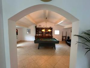 an archway in a living room with a pool table at Coeur Cevennes in La GrandʼCombe