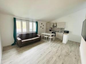 a living room with a couch and a kitchen at Il Mirto, Residenza Privata in Bacu Abis
