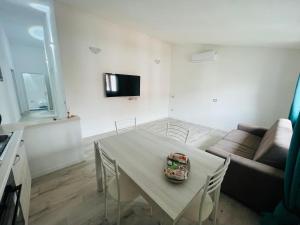 a living room with a table and a couch at Il Mirto, Residenza Privata in Bacu Abis