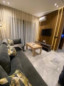 a living room with a couch and a table at studio neuf calme et propre in Casablanca