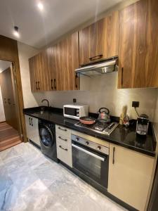 a kitchen with a stove and a microwave at studio neuf calme et propre in Casablanca