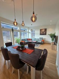 a living room with a wooden table and chairs at Hardanger Granvin Living in Granvin