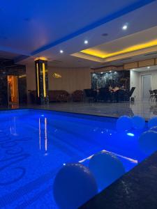 a swimming pool with blue lighting in a hotel at Vegas Hotel in Akhalk'alak'i