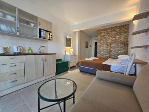 a bedroom with a bed and a table in a room at Penélope Hotel in Ialysos