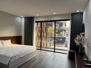 a bedroom with a large bed and a large window at HAHA'S Villa in Binh Hai +32 photos