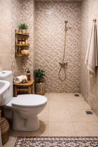 a bathroom with a toilet and a shower at Appartement moderne à 5 min de la plage de Mehdia Vacances idéales 2026 in Mehdiya-Plage +28 photos
