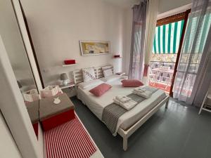 a small bedroom with a bed and a window at Chicca House in Maiori