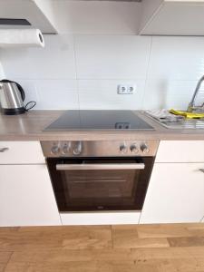 a kitchen with a stainless steel stove top oven at LuxApart2Cologne in Kerpen