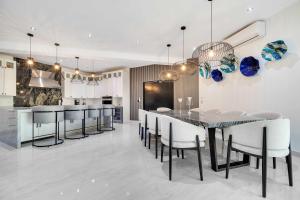 a kitchen and dining room with a table and chairs at Marbella Lane Coastal Elegance Villa with Pool in Cabo San Lucas