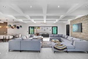 a living room with couches and a dining room at Marbella Lane Coastal Elegance Villa with Pool in Cabo San Lucas +115 photos