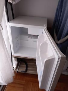 an empty white refrigerator with its door open at Cantinho da Maria in Funchal