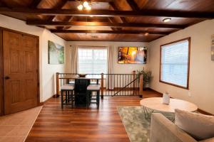 a living room with a wooden ceiling and a table at Sunlit Loft, Near GSP and Private Entry in Greer