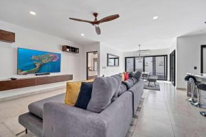 a living room with a couch and a ceiling fan at Marbella Lane Premium Ocean View Villa & Pool in Cabo San Lucas