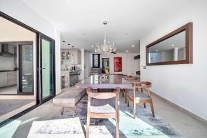 a dining room and kitchen with a table and chairs at Marbella Lane Premium Ocean View Villa & Pool in Cabo San Lucas +164 photos