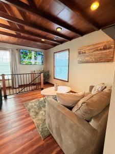 a living room with a couch and a table at Sunlit Loft, Near GSP and Private Entry in Greer