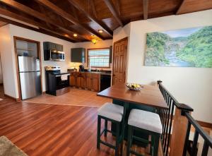 a kitchen with a wooden table and a refrigerator at Sunlit Loft, Near GSP and Private Entry in Greer +19 photos