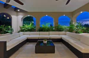 a living room with white couches and a table at Marbella lane - Stylish Private Villa OceanViews in Cabo San Lucas