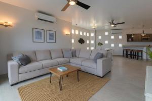 a living room with a couch and a table at Marbella lane - Stylish Private Villa OceanViews in Cabo San Lucas