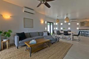 a living room with a couch and a table at Marbella lane - Chic Casa with Amazing OceanViews in Cabo San Lucas