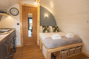 a small bedroom with a bed in a kitchen at Appin's Coorie Nook in Appin