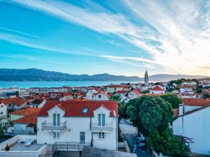 a cityscape of a town with a view of the water at House Jelka - Apartment Nina in Supetar