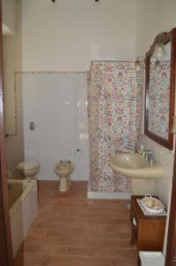 a bathroom with a sink and a toilet and a shower at Agriturismo Casal Taccone in Tarquinia