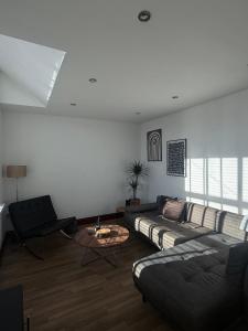 a living room with a couch and a table at Hollins Mill Apartment in Sowerby Bridge