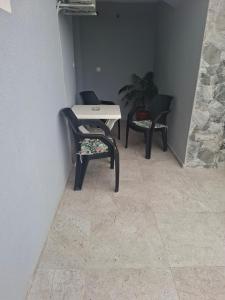two chairs and a table in a room with a wall at Apartman Skradin nono in Skradin +6 photos