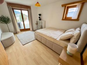 a living room with a bed and a couch at Alpine Home with Lounge - 10 min from St Moritz in La Punt-Chamues-ch