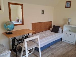 a room with a bed and a table and a mirror at Céhmesterek apartman in Eger +17 photos