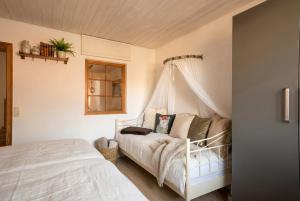 a bedroom with a white bed with a canopy at Klaushausen Ferienoase in Überlingen