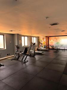 a gym with treadmills and exercise bikes in a room at MN Gotado Hotel Flat Guarulhos Aeroporto in Guarulhos