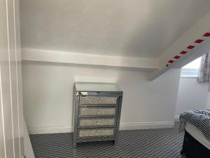 a room with a shelf in the corner of a room at Azalea apartments top floor in Sunderland +6 photos
