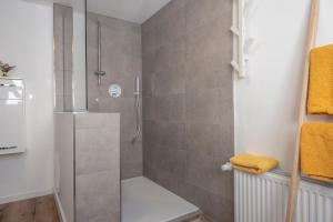 a shower with a glass door in a bathroom at Vacation, also with a dog, in Stade! in Stade +24 photos